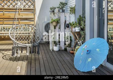 Urban penthouse terrace with acacia wood floor decorated with many ...