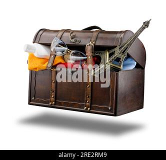 Floating trunk, on a white background. In it, accessories and symbols of the holiday. In the trunk: white sun lotion bottle, towel, sunglas Stock Photo