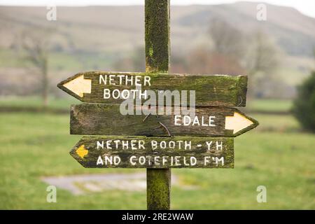 Old wooden footpath sign pointing to Nether Booth and Edale. Peak District, Derbyshire, UK Stock Photo