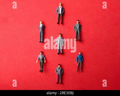 Miniature people, Businessman standing on red background. Busienss concept Stock Photo