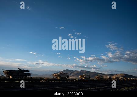 U.S. Army M1 Abrams tanks sit atop railway flatcars at the Sierra Army Depot, California, July 19, 2023. Members of the U.S. Army Medical Materiel Development Activity, U.S. Army Medical Materiel Agency, and U.S. Army Reserve Soldiers from across the 807th Medical Command (Deployment Support) began an inventory of medical supplies this week as part of a capstone field hospital conversion mission for eight Army Reserve medical commands belonging to the 801st Combat Support Hospital. Logisticians with USAMMDA’s Force Sustainment Directorate partner with both active and reserve commands in the Jo Stock Photo