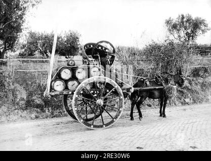 Albano, Italy:  January, 1934 A man in his highly decorated two wheeled cart carrying barrels of wine to town along the new Appian Road. Stock Photo