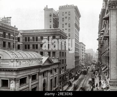 Los Angeles, California:  c. 1900. Looking down Fourth Street from Main towards Spring Street, with the Farmers and Merchants Bank at the near left and the tall Hibernian Building just beyond. Stock Photo
