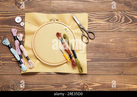 Set of different embroidery supplies on grey background Stock