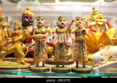 Indian marble dolls playing indian instruments. Hand painted handicraft dolls. Three woman dolls for sale. Stock Photo