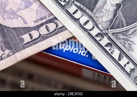 A opioid drugs addiction concept with a box of medicine containing opioid and Dollar bills on top. Stock Photo