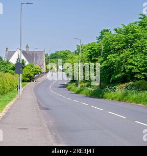 Looking down the Main Street in Howwood towards the old Parish Church and its Bell Tower Stock Photo