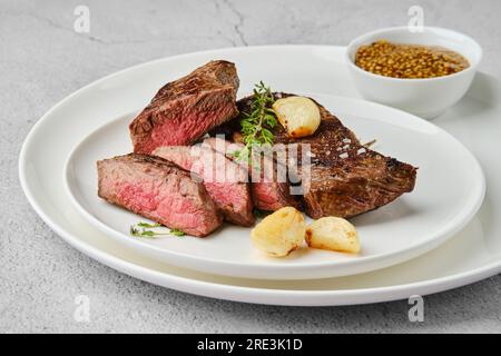Beef strip steak medium rare on a plate Stock Photo