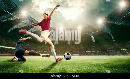 Motivated young women, football, soccer players during match, game, hitting ball, scoring winning goal. 3d arena, sports field Stock Photo