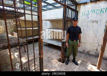 Police officer from the Panama police force outside a cell in the old prison at Coiba Island, Pacific coast, Veraguas Province, Republic of Panama. Stock Photo