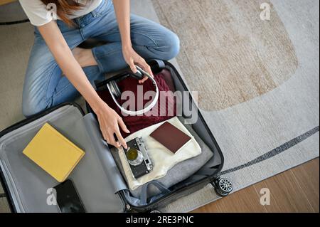 attractive girl packing suitcase for vacation Stock Photo - Alamy