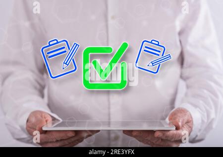 Document validation concept above a tablet held by a man in background Stock Photo