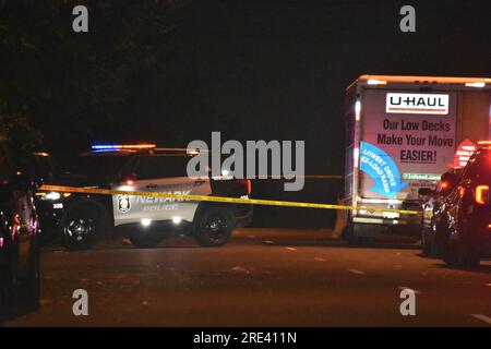 Authorities comb the area for ballistics evidence prior to the Essex County Prosecutor's Office homicide task force arrival. Newark Police place crime scene tape to protect the evidence at the crime scene. A shooting transpired in Newark, New Jersey after 10:00 PM, Monday afternoon in two separate locations. One shooting occurred in the area of Clinton Place and the second shooting occurred in the area of Johnson Avenue which are blocks apart from each other. Three people were shot with two of those individuals unresponsive. Casualties were reported, however an exact number was not immediately Stock Photo