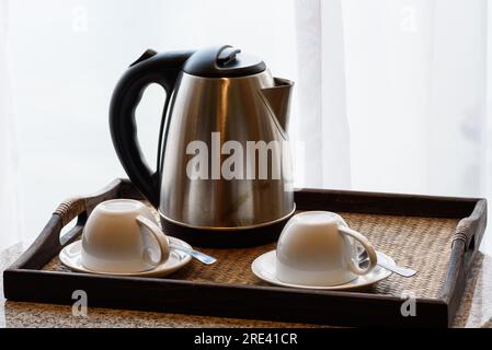 Electric kettle and coffee cup set in hotel room, ceramic cup set, Stock Photo