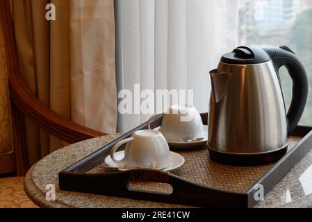 Electric kettle and coffee cup set in hotel room, ceramic cup set, Stock Photo