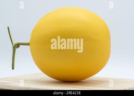 Close up Honeydew melon on wood table isolated on white background Stock Photo