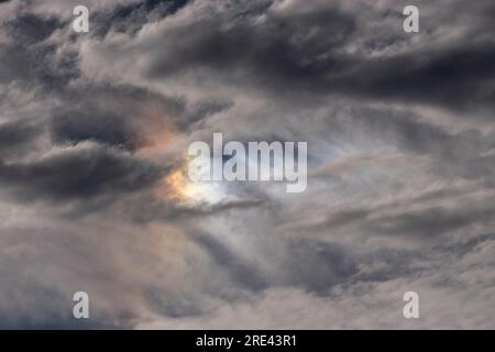 Sundog or parhelion - a mini rainbow when cold weather brings ice crystals into high, cold cirrus clouds. Light is refracted. Australia, winter. Stock Photo