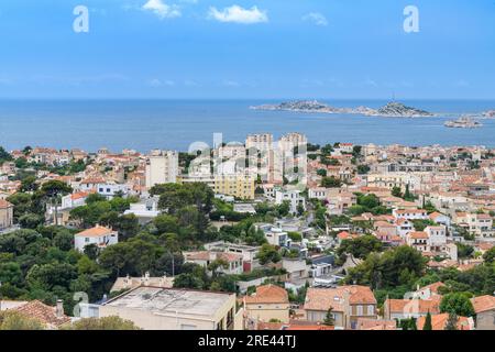 Cityscape over Marseille, shot from Basilica of Notre-Dame of la Garde, overlooking terracotta rooftops, winding streets and distant mountains. Stock Photo