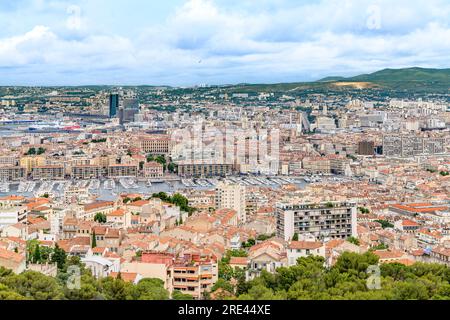 Cityscape over Marseille, shot from Basilica of Notre-Dame of la Garde, overlooking terracotta rooftops, winding streets and distant mountains. Stock Photo