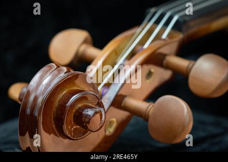 Close up of wooden violin on a dark background Stock Photo