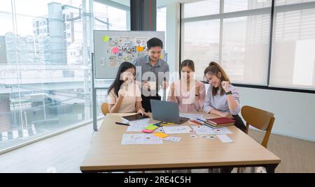ux developers and ui designers and Asian business people are enjoying their startup business. Stock Photo