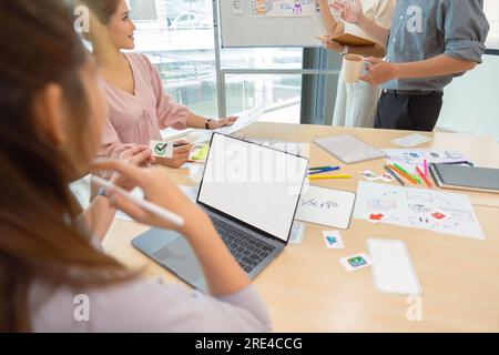 ux developers and ui designers listening to mobile app presentations in conference in front of laptop Stock Photo