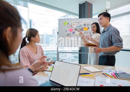 ux developers and ui designers listening to mobile app presentations in conference in front of laptop Stock Photo