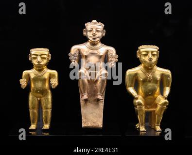 Gold statuettes of Quimbayan Chiefs seated on stools, indicating power, and standing, adorned with various caracteristic elements of their rank. Quimb Stock Photo