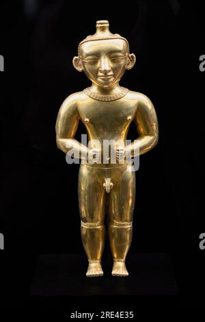 Gold statuette of a standing Quimbayan Chief adorned with various caracteristic elements of his rank. Quimbaya culture, 200 - 1000 AD. Colombia. Museu Stock Photo