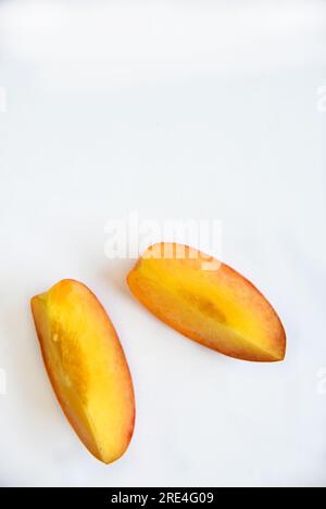 Sliced fresh peaches on a white background. Vegetarian food. Stock Photo