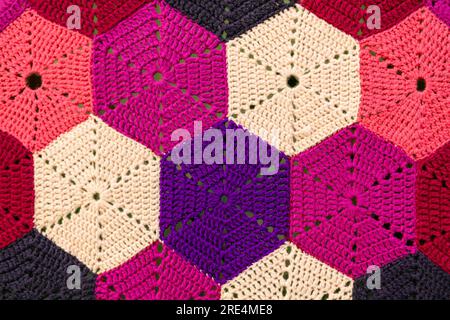 Handmade colorful crocheted background. Close-up of knitted pattern Stock Photo