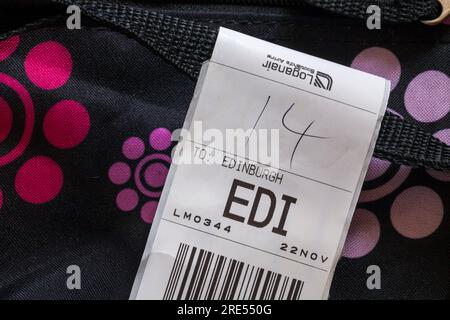 Loganair luggage label stuck on case for EDI Edinburgh airport in Scotland Stock Photo