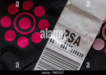 BA British Airways luggage label stuck on case for PSA Pisa airport in Italy Stock Photo