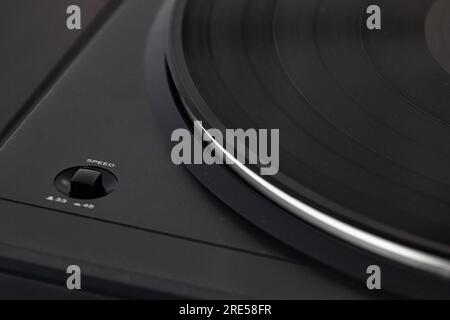 Black vinyl on spinning player with speed button. Duotone black and white, clean composition for audio and musical background Stock Photo