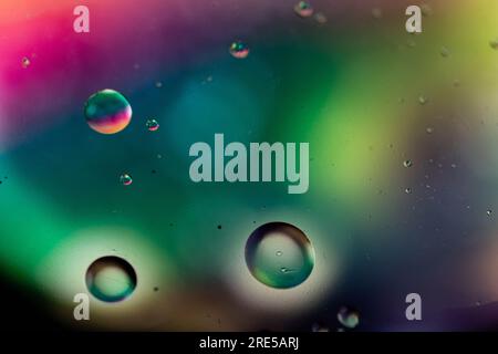 Color oil drop abstract background, Flat images with blurred and sharpen circles together with multicolor background. Stiring water and oil for dynami Stock Photo