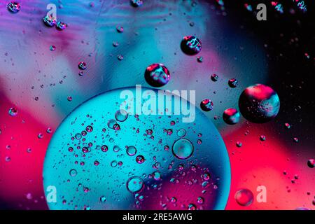 Color oil drop abstract background, Flat images with blurred and sharpen circles together with multicolor background. Stiring water and oil for dynami Stock Photo