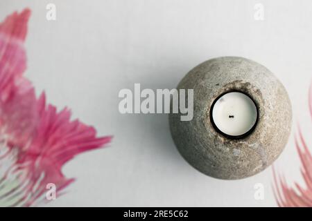 Candle in natural stone on white background. Interior decoration backdrop, minimal design for house decoration and home design Stock Photo