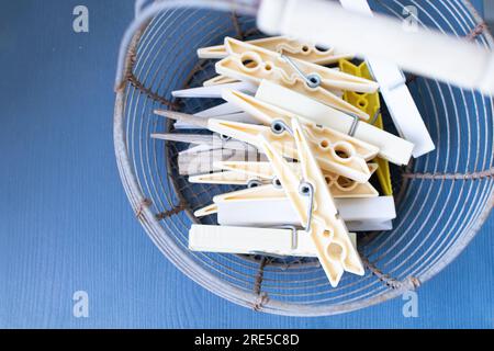 basket of clothes pegs on a blue background. Vintage background Stock Photo