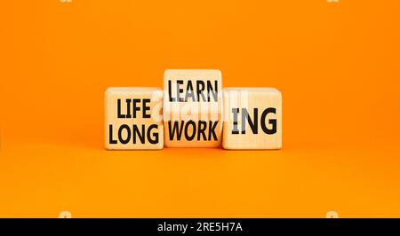 Lifelong learning working symbol. Concept word Lifelong learning working on block on a beautiful orange background. Business educational lifelong lear Stock Photo