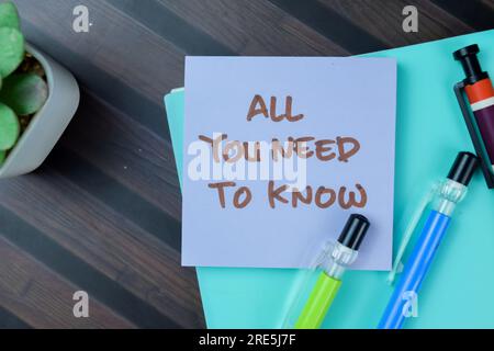 Concept of All You Need To Know write on sticky notes isolated on Wooden Table. Stock Photo
