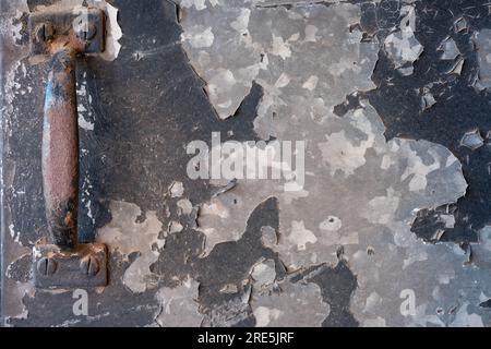 Rusted door handle on metal with rusted and peeling paint Stock Photo