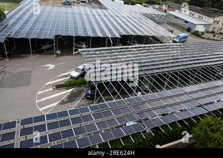 Solar panels installed on the roof of a car parking in the city. Stock Photo