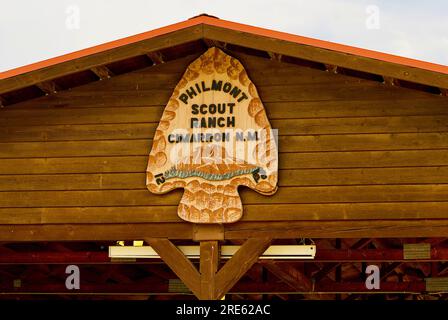 Cimarron, New Mexico, USA - July 24, 2023: Close-up view of the Philmont Scout Ranch 'patch' logo on the side of a pavilion near its main entrance. Stock Photo
