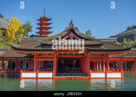 A building and pagoda at high tide at Itsukushima Shinto shrine on Itsukushima (or Miyajima) Island in Hiroshima Prefecture, Japan. Stock Photo