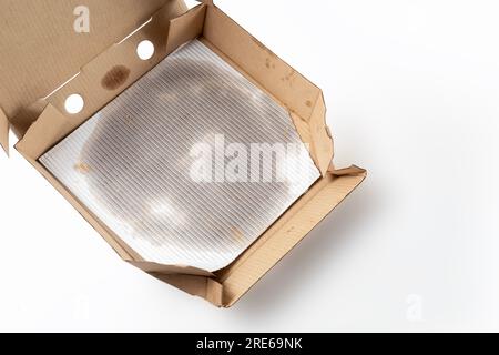 Empty pizza box with grease stains isolated on white. Top view. Stock Photo