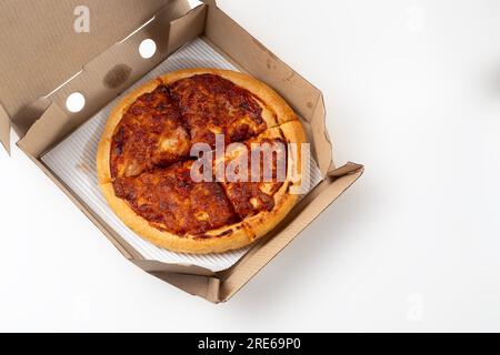 Margherita Pizza in a cardboard box against a white background. Pizza delivery. Stock Photo