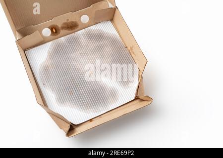 Empty pizza box with grease stains isolated on white. Top view. Stock Photo