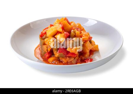 Pepper stew with potatoes in tomato sauce in white dish isolated on white with clipping path included Stock Photo