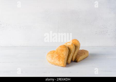 Shortbread cookies in the shape of a heart on a light blue background. cookie day. Stock Photo