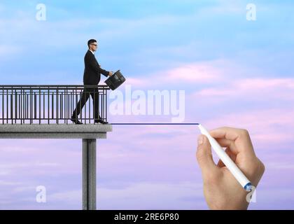 Support or partnership concept. Man drawing bridge to help businessman walk forward Stock Photo